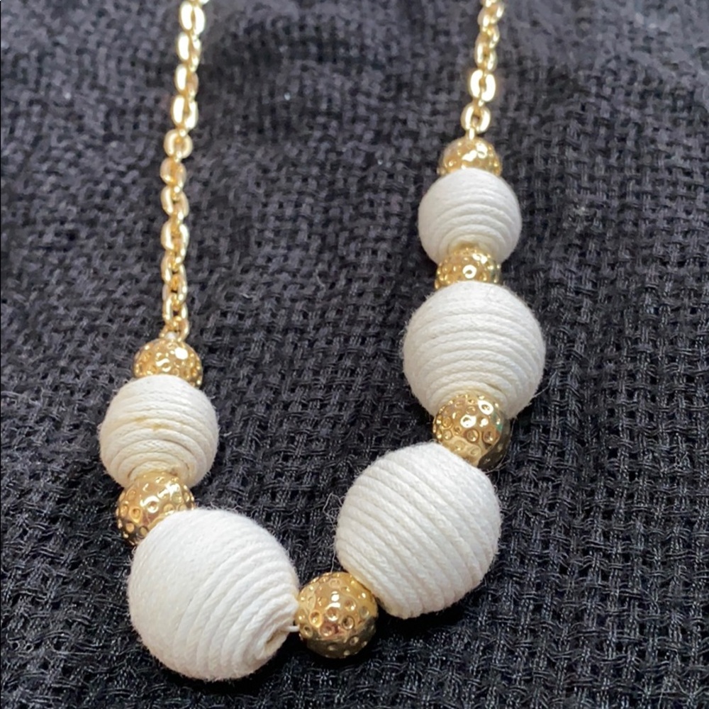 Gold necklace with white and gold balls